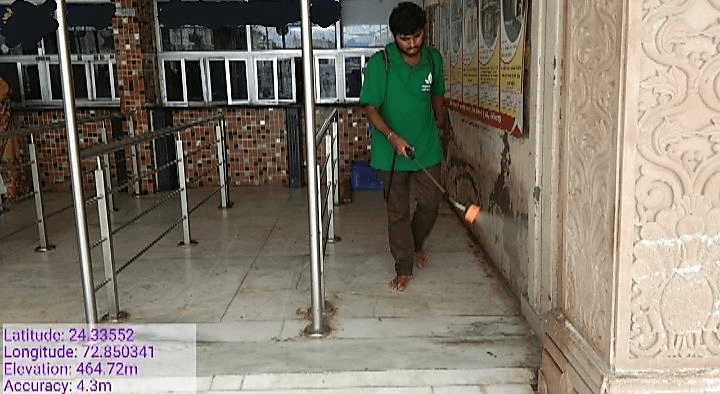 Men Cleaning Temple Using a Machine