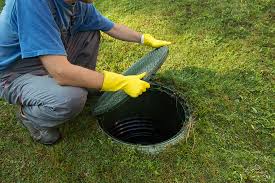 Men Opening a Septic Tank Lid