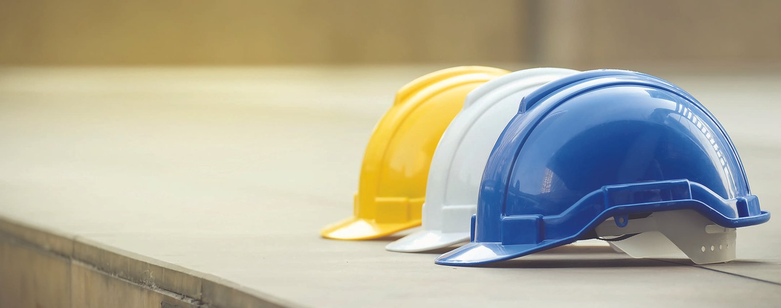 three hard construction hats lined up