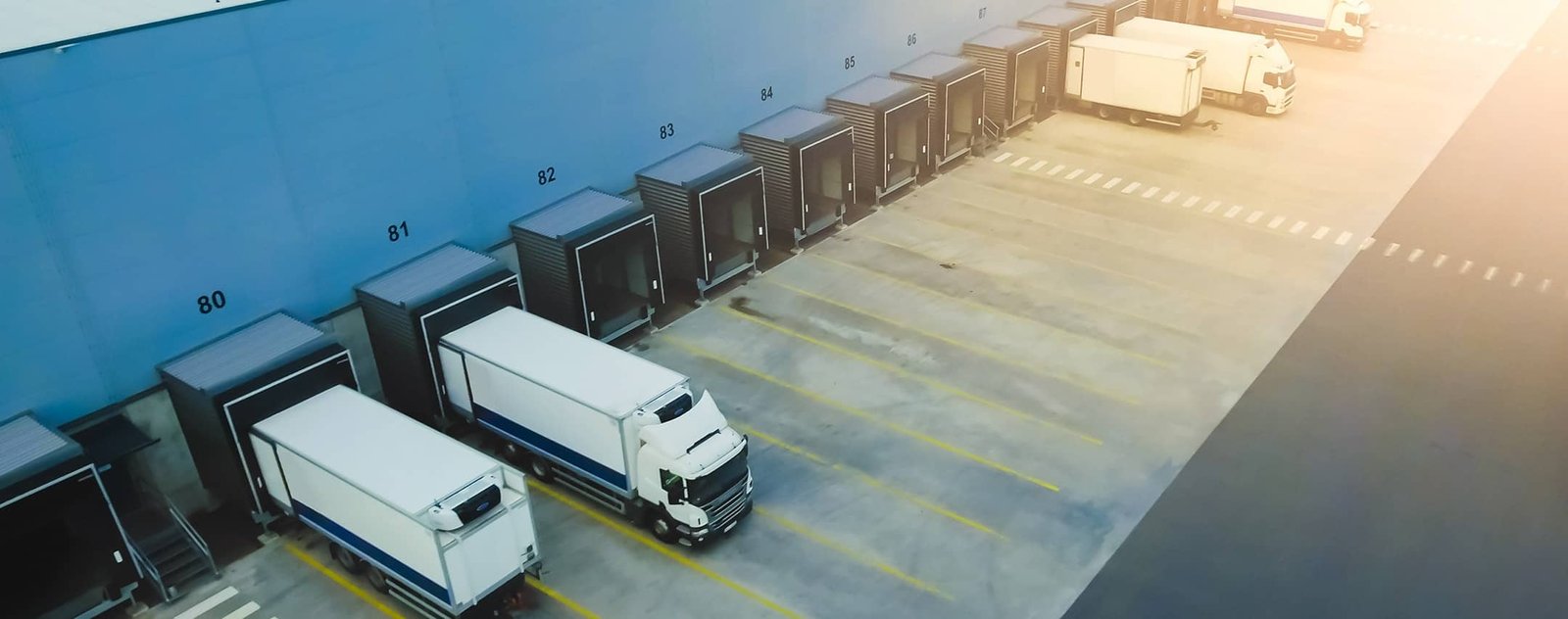 aerial view of semi trucks backing into the loading dock