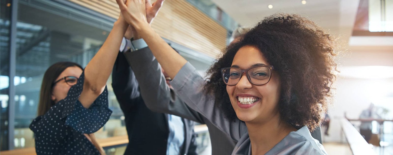 two ladies putting their hands together and smiling