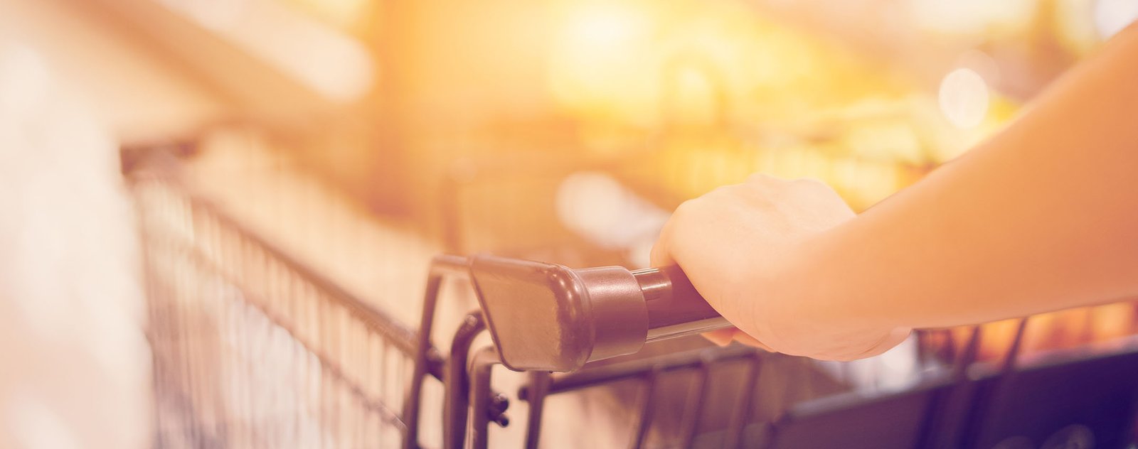 close up of woman pushing a shopping cart